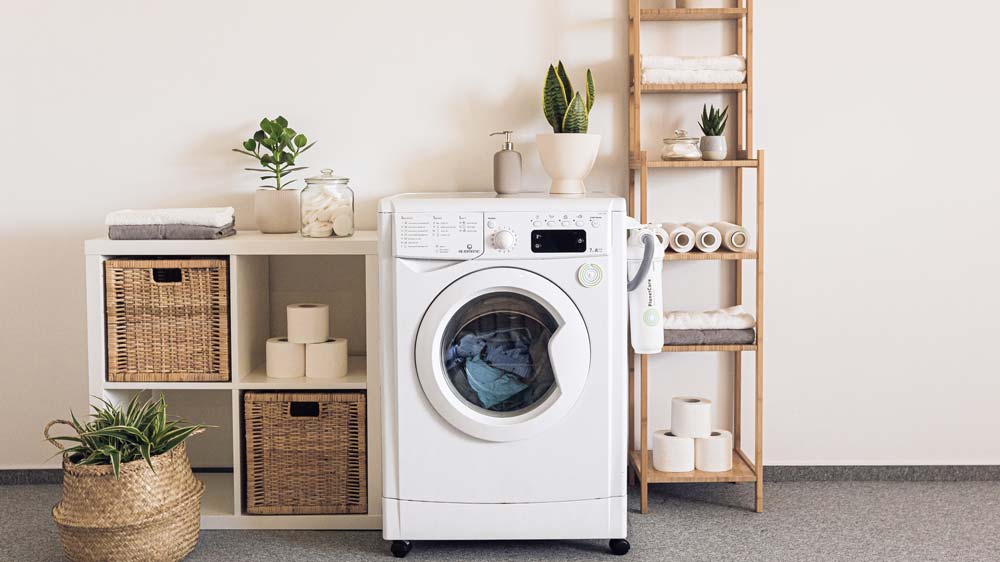 A laundry room with a single white washer/dryer
