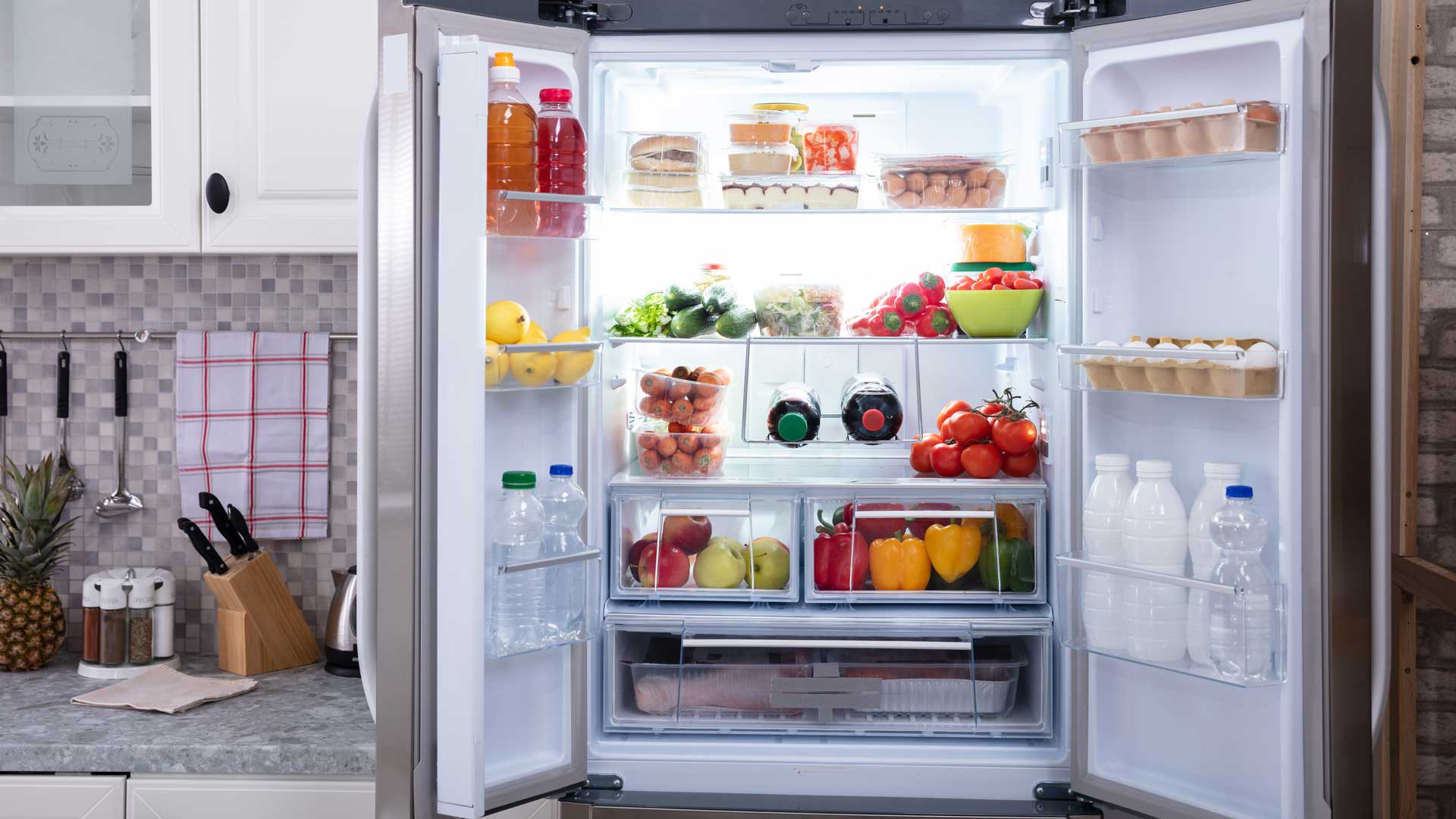 Refrigerator, doors open to show food inside